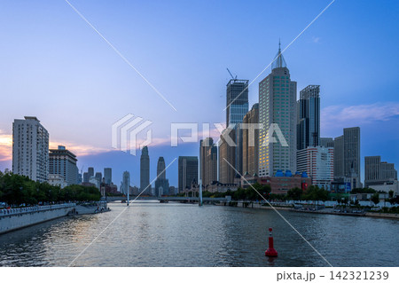 city skyline and skyscrapers along Haihe River at twilight in Tianjin China 142321239