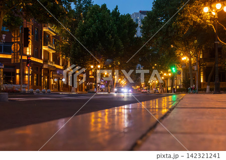 low angle view of illuminated city street and classic architecture at night in Tianjin 142321241