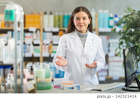 Portrait of pharmacist girl inviting to visit modern drugstore Portrait of pharmacist girl inviting to visit modern drugstore 142321414