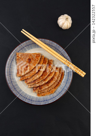 crispy rolled Indian whole wheat flatbread paratha served on a basket crispy rolled Indian whole wheat flatbread paratha served on a basket 142322557