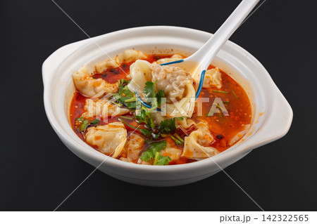 sichuan spicy wonton dumplings in red chili oil broth with cilantro sichuan spicy wonton dumplings in red chili oil broth with cilantro 142322565