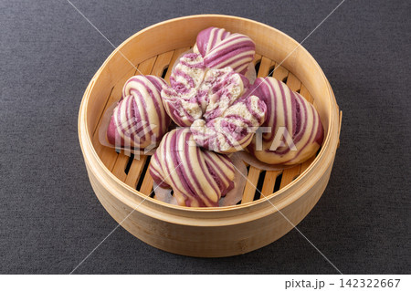 layered purple sweet potato swirl steamed buns huajuan in woven basket 142322667
