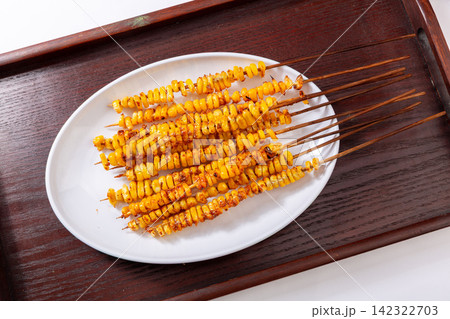asian style grilled sweet corn skewers seasoned with spices on tray asian style grilled sweet corn skewers seasoned with spices on tray 142322703