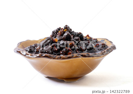 spicy fermented black soybeans condiment with chili oil on golden spoon spicy fermented black soybeans condiment with chili oil on golden spoon 142322789