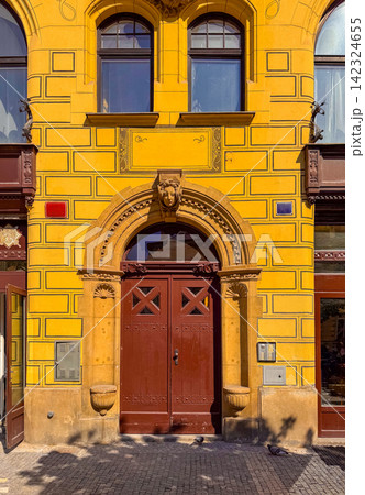 Building with yellow walls and detailed door design in Prague 142324655