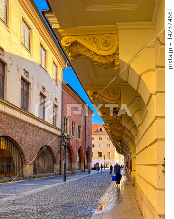 A historic street with ornate arches during the day 142324661