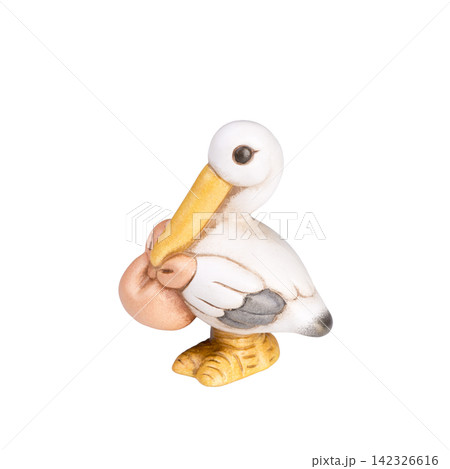 A ceramic figurine of a white stork carrying a baby bundle in its beak stands A ceramic figurine of a white stork carrying a baby bundle in its beak stands 142326616