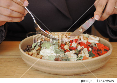 Eating salad at a restaurant in the afternoon Eating salad at a restaurant in the afternoon 142326989