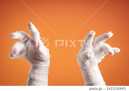 Halloween. Mummy hands stretch out with an eerie vibe perfect for Halloween Halloween. Mummy hands stretch out with an eerie vibe perfect for Halloween 142328445