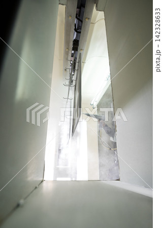 Industrial spray painting inside metal enclosure with mist and bright lighting Industrial spray painting inside metal enclosure with mist and bright lighting 142328633