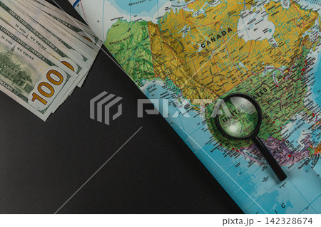 Planning a travel budget with cash and a map for a trip to the United States Planning a travel budget with cash and a map for a trip to the United States 142328674