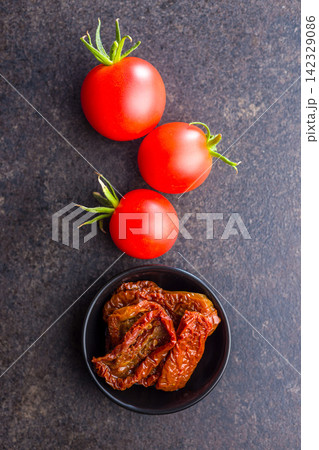 Sun-Dried Tomatoes in Bowl with Fresh Cherry Tomatoes and Olive Oil - Gourmet Mediterranean Ingredient Sun-Dried Tomatoes in Bowl with Fresh Cherry Tomatoes and Olive Oil - Gourmet Mediterranean Ingredient 142329086
