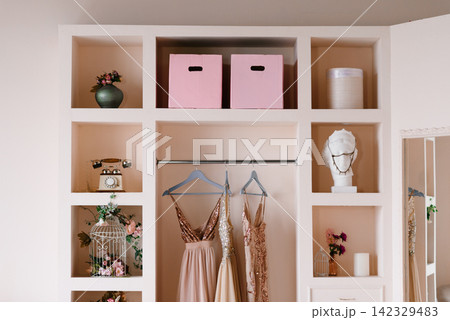 Wardrobe Interior With Antique Bust And Festive Dresses 142329483