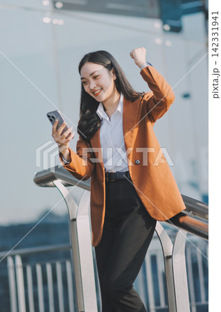 Young businesswoman smiling while working with digital tablet at modern office building Young businesswoman smiling while working with digital tablet at modern office building 142331941