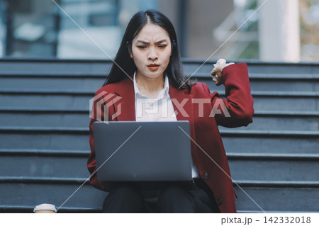 Asian woman in sitting at stairway outdoor have a stressed, after being laid off unemployed. Desperate be out of work. Asian woman in sitting at stairway outdoor have a stressed, after being laid off unemployed. Desperate be out of work. 142332018