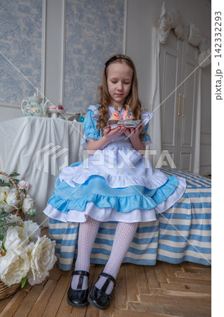 Young Girl Arranging Tea Set, Pastel Bedroom Scene With Striped Bedspread, Porcelain Plates And Small Cake, Ribboned Bouquet On Floor, Lace Apron And Headband, Soft Natural Light, Playful Focused 142332293