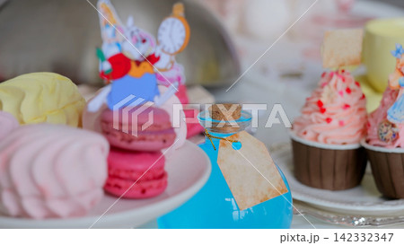 Whimsical Easter Tea Party With Rabbit Topper Pink Macarons And Marshmallows Arranged On Cake Stand, Paper Rabbit Ornament Holding Tiny Clock, Cupcakes With Heart Sprinkles, Soft Pastel Palette, Whimsical Easter Tea Party With Rabbit Topper Pink Macarons And Marshmallows Arranged On Cake Stand, Paper Rabbit Ornament Holding Tiny Clock, Cupcakes With Heart Sprinkles, Soft Pastel Palette, 142332347