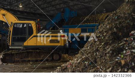 Massive plastic waste pile under a conveyor belt at a recycling plant, waste sorting, recycling, sustainability, circular economy, and environmental protection. 142332366