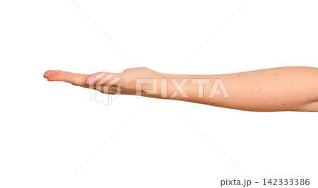 Female palm faces upward presenting something unseen. Fingers stay relaxed as if displaying an 142333386