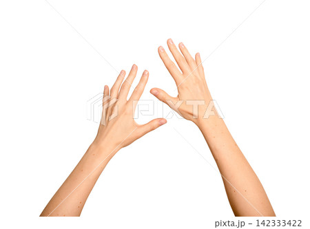 Two female hands interact with an unseen digital object. Fingers reach and touch something invisible 142333422