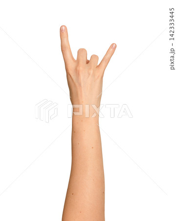 Female right hand throws up a hard rock sign. Index and little finger point up while others curl Female right hand throws up a hard rock sign. Index and little finger point up while others curl 142333445