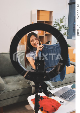 Woman recording live stream preparing packages for online selling Woman recording live stream preparing packages for online selling 142333848