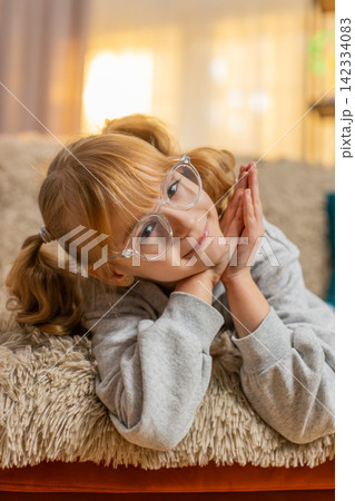 Portrait of young teenager girl looking at camera with a friendly smile and happy expression indoors Portrait of young teenager girl looking at camera with a friendly smile and happy expression indoors 142334083