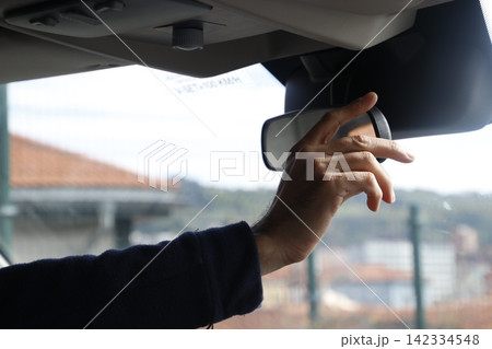 Man checking the mirror of his car 142334548