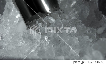 Crushed ice filling a metal scoop, ready for cooling beverages and maintaining freshness for various products Crushed ice filling a metal scoop, ready for cooling beverages and maintaining freshness for various products 142334697