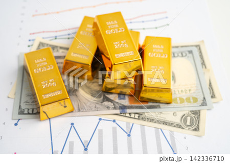 Gold bars on US dollar banknote money, finance trading investment business currency. 142336710