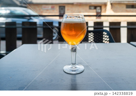 Enjoying a drink at a table on a sunny day outside a cafe Enjoying a drink at a table on a sunny day outside a cafe 142338819