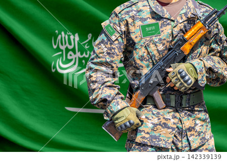 Saudi Arabia flag with soldier holding assault rifle Saudi Arabia flag with soldier holding assault rifle 142339139