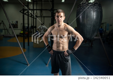 Athlete standing with hands on hips after boxing training 142340051