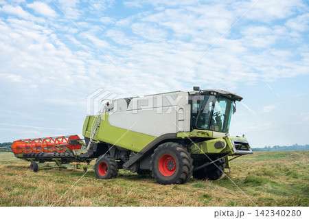 Combine Harvester with Header Trailer Ready for Transport 142340280