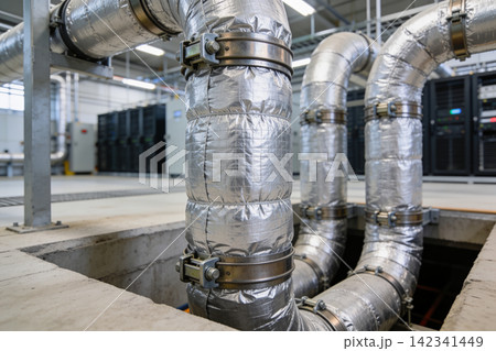 Industrial insulated pipes with metal clamps in a modern facility Industrial insulated pipes with metal clamps in a modern facility 142341449