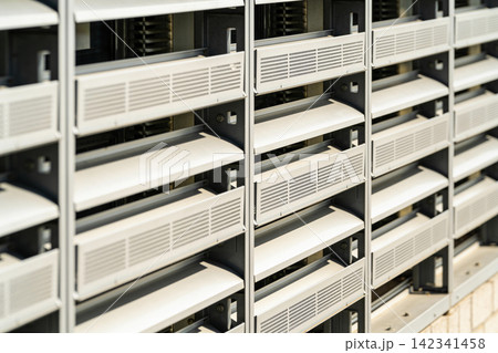 Modern building facade with repeating louvers and ventilation grilles Modern building facade with repeating louvers and ventilation grilles 142341458