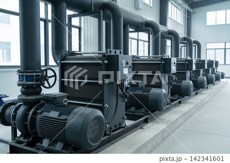 Industrial pumps and piping system in a modern factory setting Industrial pumps and piping system in a modern factory setting 142341601