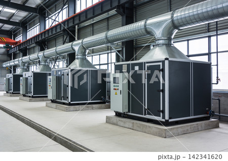 Industrial HVAC units with large ventilation ducts in a modern factory building 142341620