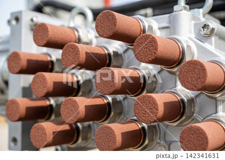 Close-up of industrial hydraulic pump manifold with multiple bronze silencers Close-up of industrial hydraulic pump manifold with multiple bronze silencers 142341631