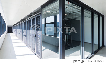 Modern data center hallway with rows of server racks and glass partitions Modern data center hallway with rows of server racks and glass partitions 142341685