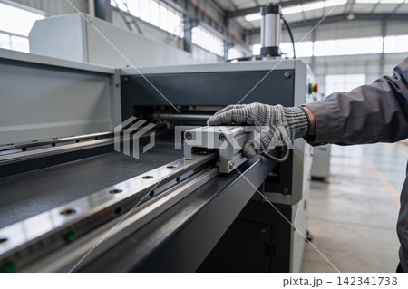 Industrial worker's gloved hand operating precision linear motion guide system Industrial worker's gloved hand operating precision linear motion guide system 142341738