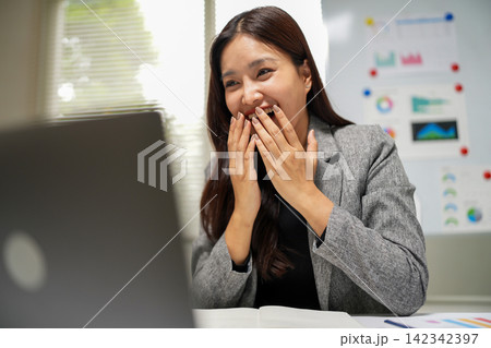 Successful Businesswoman Reacting with Surprise During Laptop Meeting 142342397
