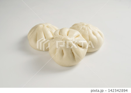 Soft steamed bao buns with pleated tops on white background 142342894