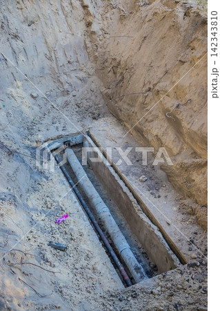 Excavated water pipes after replacement near the old house. Pipe Excavated water pipes after replacement near the old house. Pipe 142343810