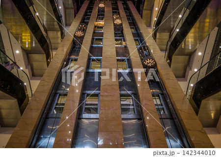 UKRAINE. KYIV - 13 JUNE 2021. View of moving elevators, walls, and balconies of the contemporary business center that can be used as background 142344010