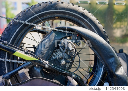 Broken electric bicycle with pulled out inner tube and flat rear tire Broken electric bicycle with pulled out inner tube and flat rear tire 142345008