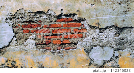 A damaged wall texture featuring exposed red brick and peeling plaster. A damaged wall texture featuring exposed red brick and peeling plaster. 142346028