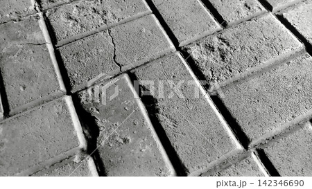 Cracked black and white concrete paving block texture 142346690