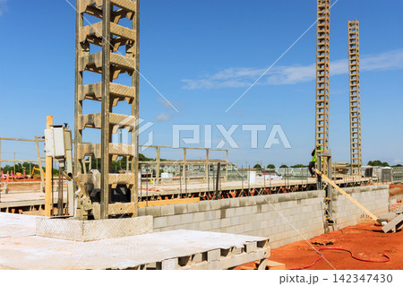 Workers are building walls with concrete blocks at construction site Workers are building walls with concrete blocks at construction site 142347430
