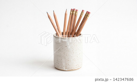 Sharpened wooden pencils inside a ceramic holder with stationery supplies education sketching equipment vertical container speckled ceramicware sharpened graphite lighting isolated Sharpened wooden pencils inside a ceramic holder with stationery supplies education sketching equipment vertical container speckled ceramicware sharpened graphite lighting isolated 142347686